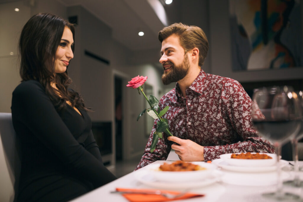 Man giving rose to girl